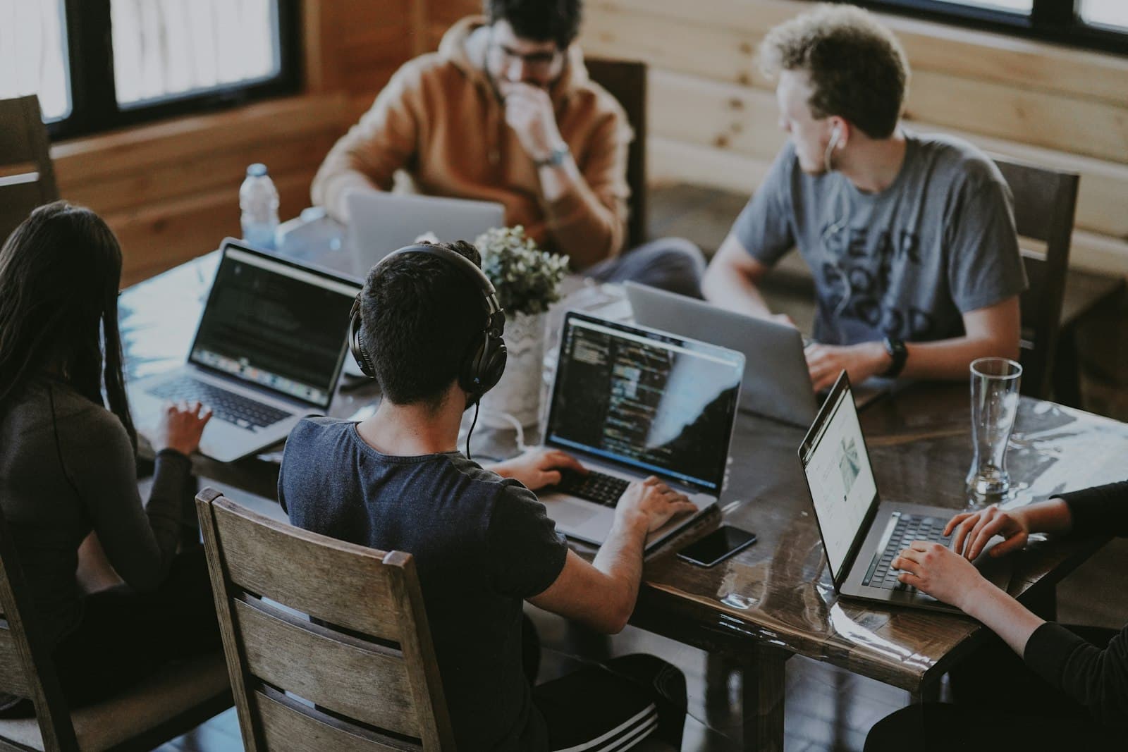 A development team working on laptops around a shared table